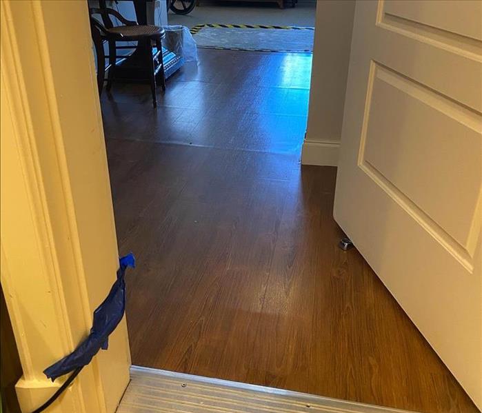flooring with water damage in the entry