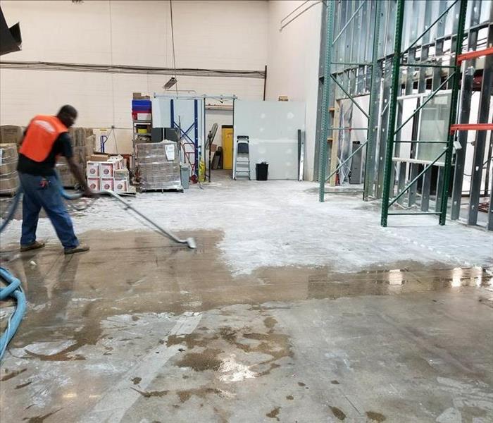 SERVPRO of Denver East employee continuing to clean up water damage in Denver warehouse.