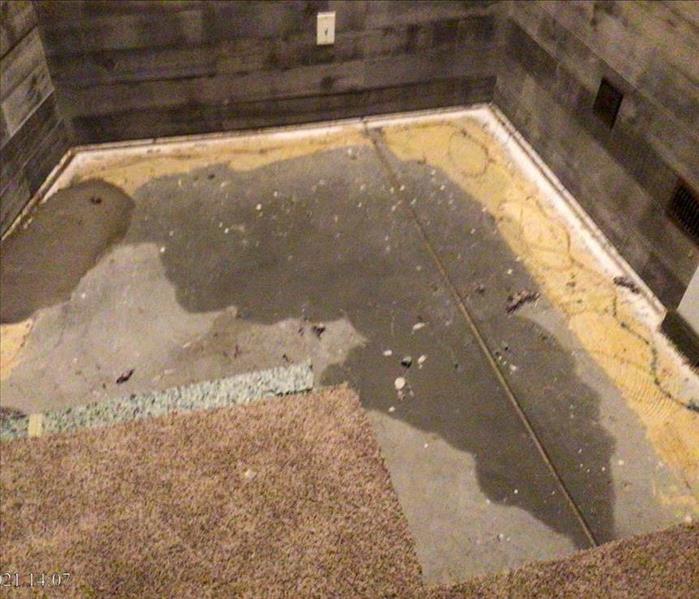 Basement with wet carpet and carpet pad removed to prevent mold