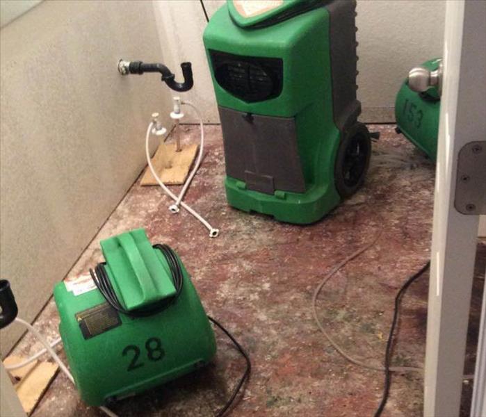 Wet materials removed from water damaged bathroom and drying equipment set up