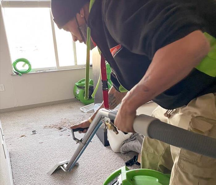 SERVPRO employee using an extraction unit