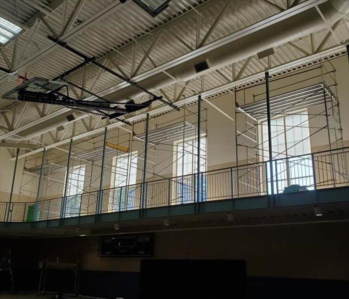 Scaffolding set up on a second level area of a gymnasium for the purpose of fire damage restoraiton