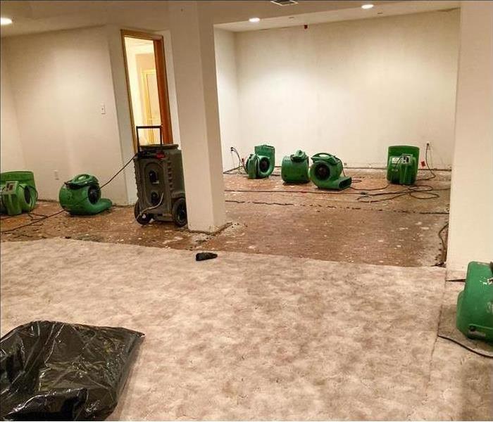 Drying equipment in a commercial building, carpet removal.