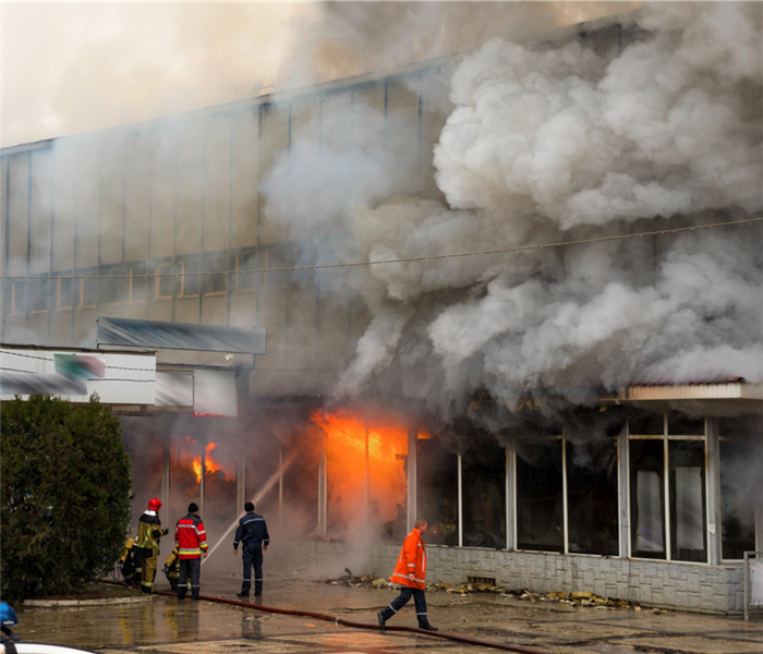 Firefighters putting out a fire in a big building